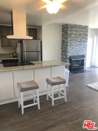 a kitchen with a chair and a fireplace