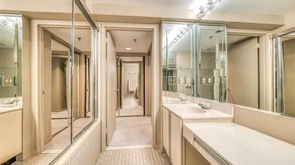 a bathroom with a tub sink shower and mirror
