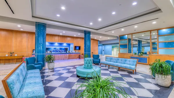 a lobby with furniture and a potted plant