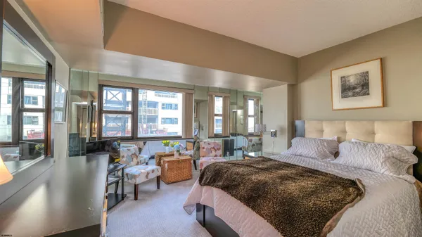 a bedroom with a large bed and a large window