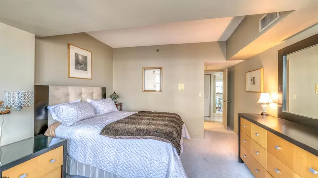 a bedroom with a bed and a couch