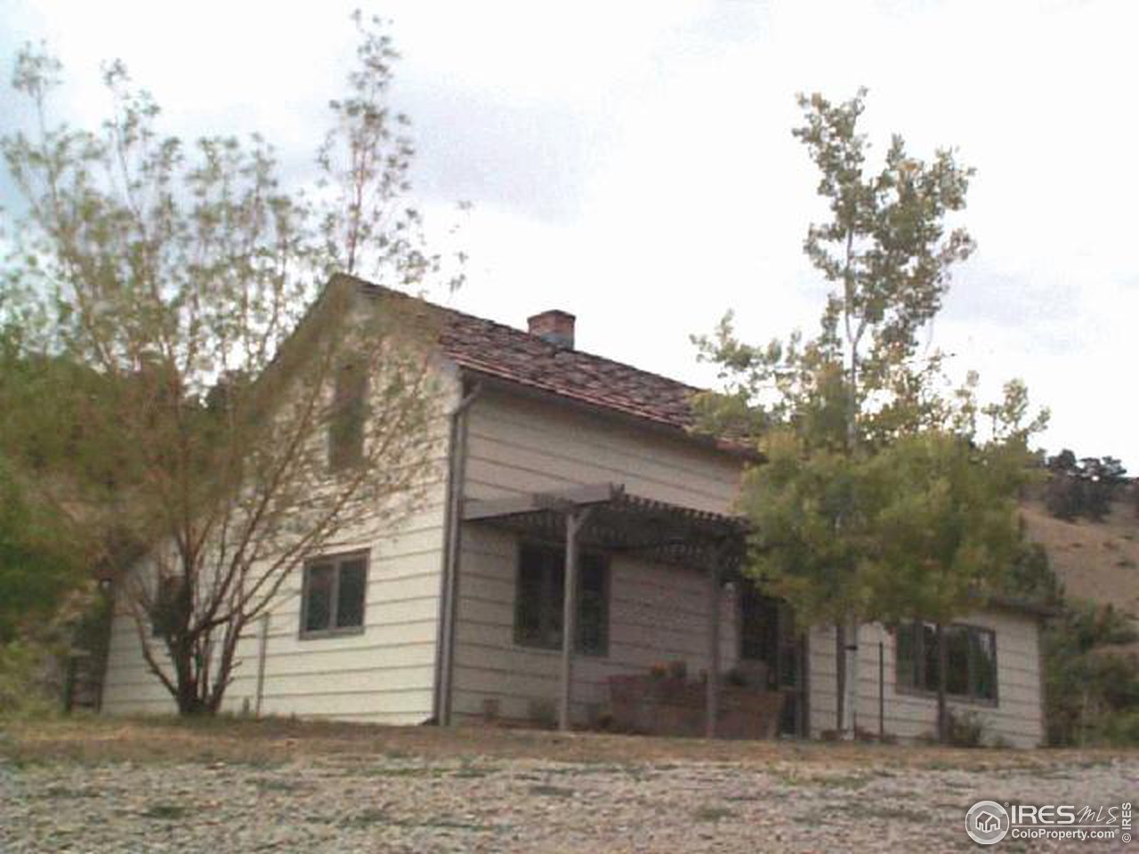 a view of a house with a tree