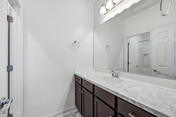 a bathroom with a sink a vanity and a mirror