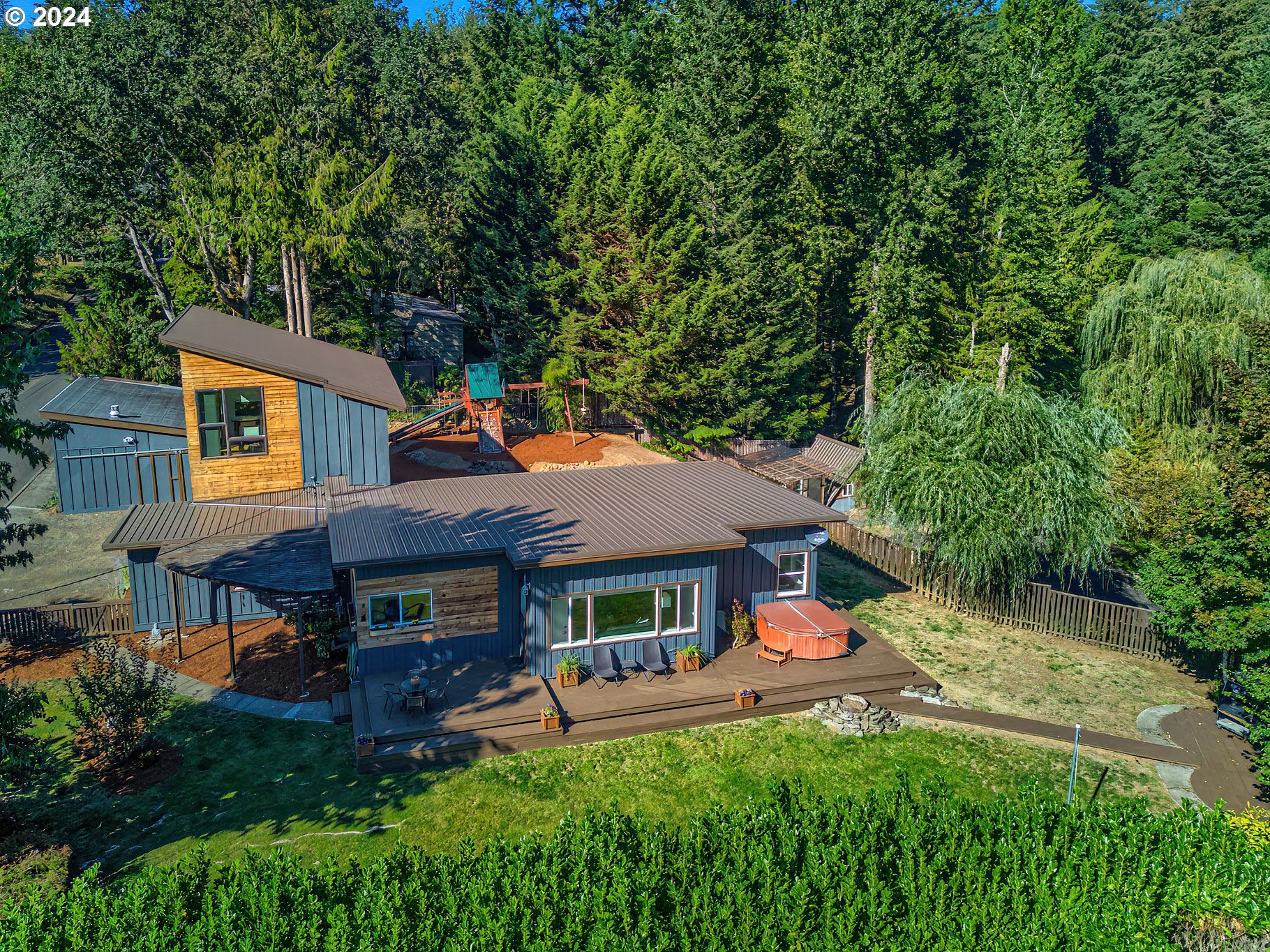 450 Frank Johns Road Stevenson, WA 98648 - Photo 2 of 36 an aerial view of a house with table and chairs under an umbrella