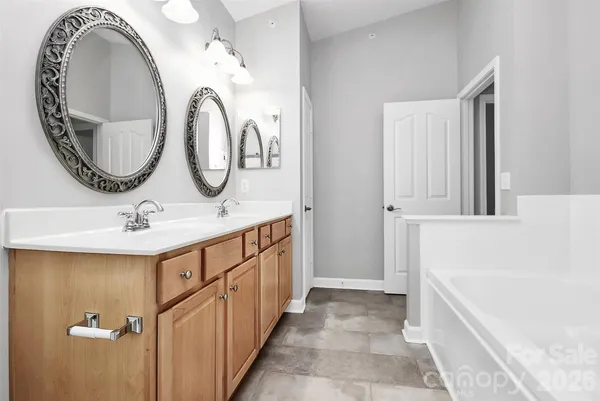 a bathroom with a double vanity sink and a mirror