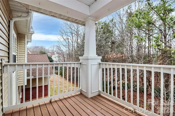 a view of a balcony with wooden floor