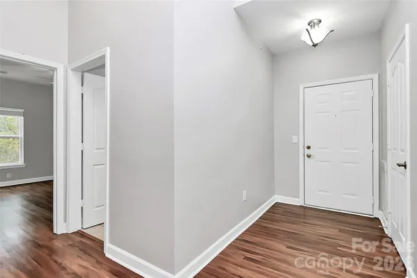 a view of a livingroom with wooden floor and a ceiling fan