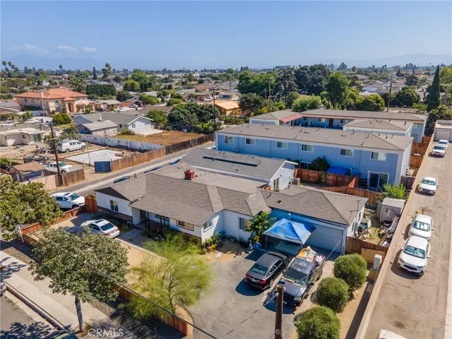 a view of a city with lawn chairs and ocean view