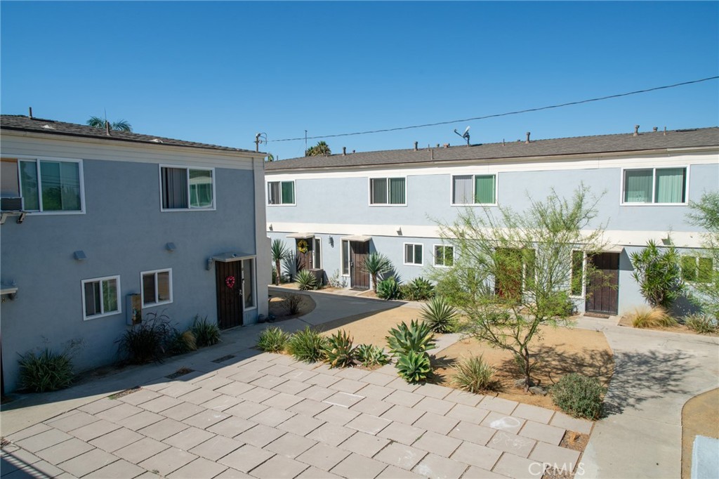 13392 Magnolia Street Garden Grove, CA 92844 - Photo 8 of 15 a front view of a house with a yard and potted plants