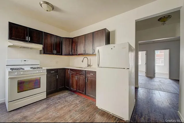 a kitchen with a refrigerator sink and cabinets