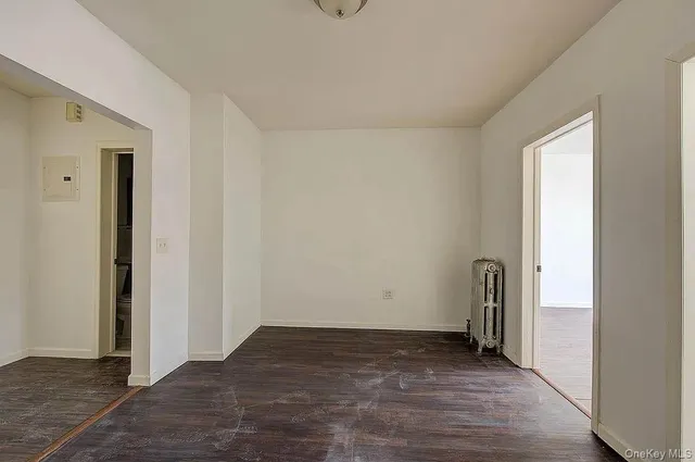 an empty room with wooden floor and sliding door