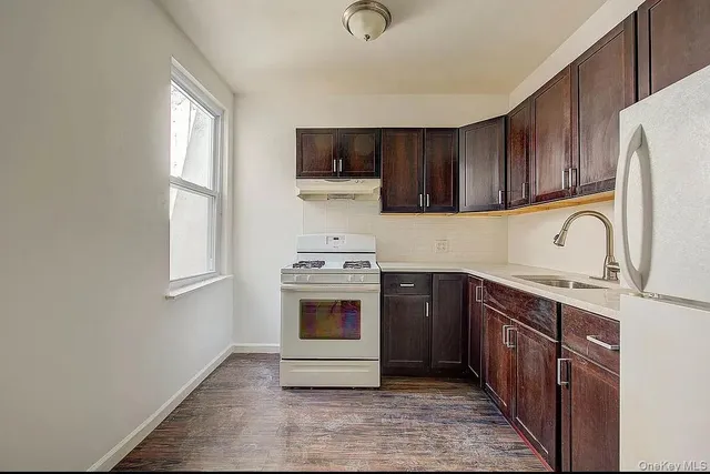 a kitchen with stainless steel appliances granite countertop a stove a sink dishwasher and a refrigerator