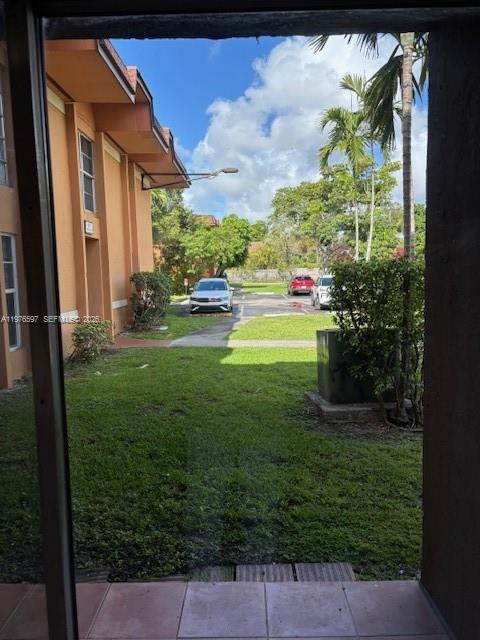 9493 Southwest 76th Street, Unit L4 Miami, FL 33173 - Photo 12 of 33 a view of back yard of the house