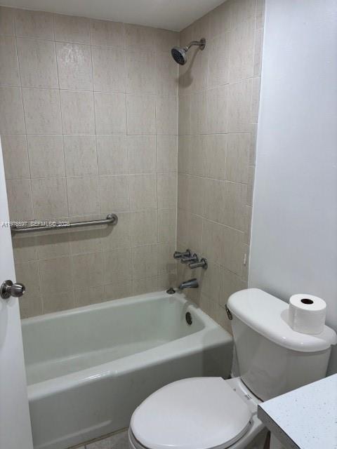 9493 Southwest 76th Street, Unit L4 Miami, FL 33173 - Photo 15 of 33 a white toilet and tub sitting next to a bathroom sink