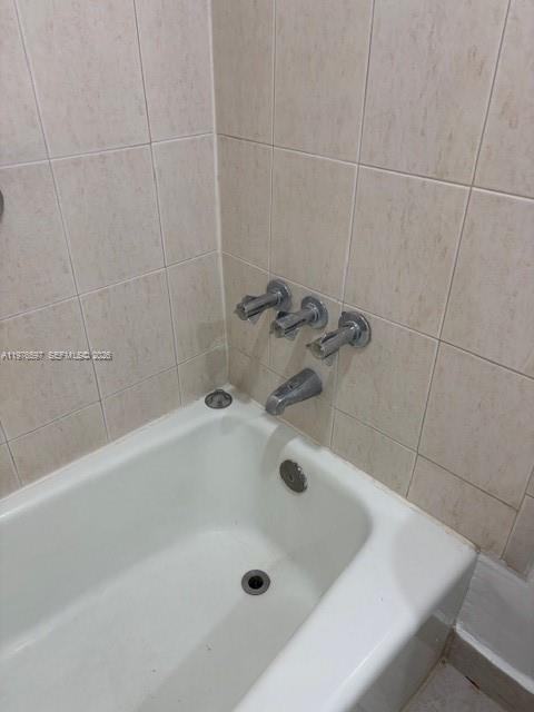 9493 Southwest 76th Street, Unit L4 Miami, FL 33173 - Photo 16 of 33 a bath tub sitting in a bathroom and a sink