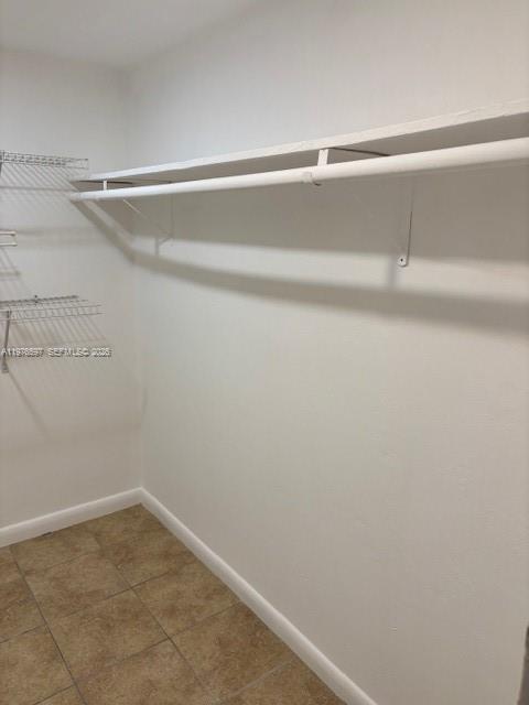 9493 Southwest 76th Street, Unit L4 Miami, FL 33173 - Photo 24 of 33 a view of a room with racks on the wall
