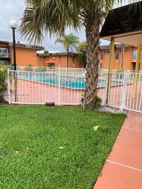 9493 Southwest 76th Street, Unit L4 Miami, FL 33173 - Photo 28 of 33 a view of backyard with palm trees