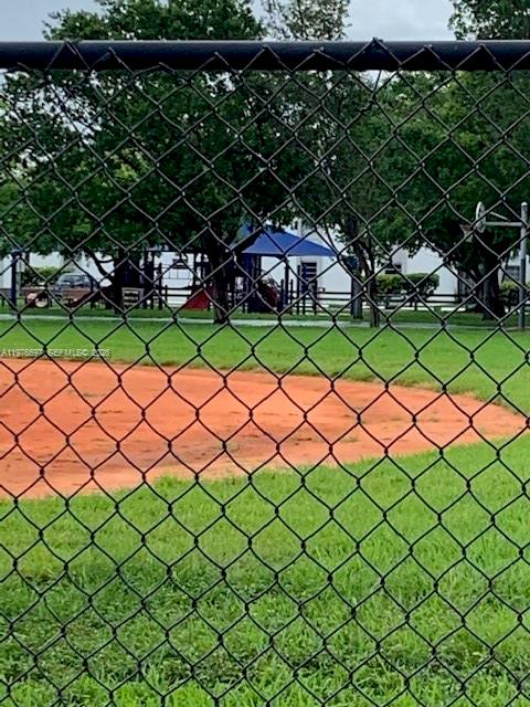 9493 Southwest 76th Street, Unit L4 Miami, FL 33173 - Photo 31 of 33 a view of a yard and iron fence