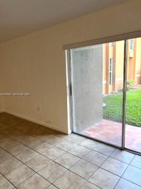 9493 Southwest 76th Street, Unit L4 Miami, FL 33173 - Photo 9 of 33 a view of backyard with window and entryway
