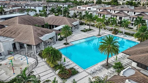 an aerial view of house with swimming pool and outdoor seating