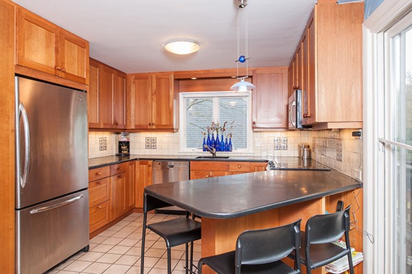 18 Fredana Road Newton, MA 02468 - Photo 4 of 7 a kitchen with stainless steel appliances granite countertop a refrigerator a sink and a stove