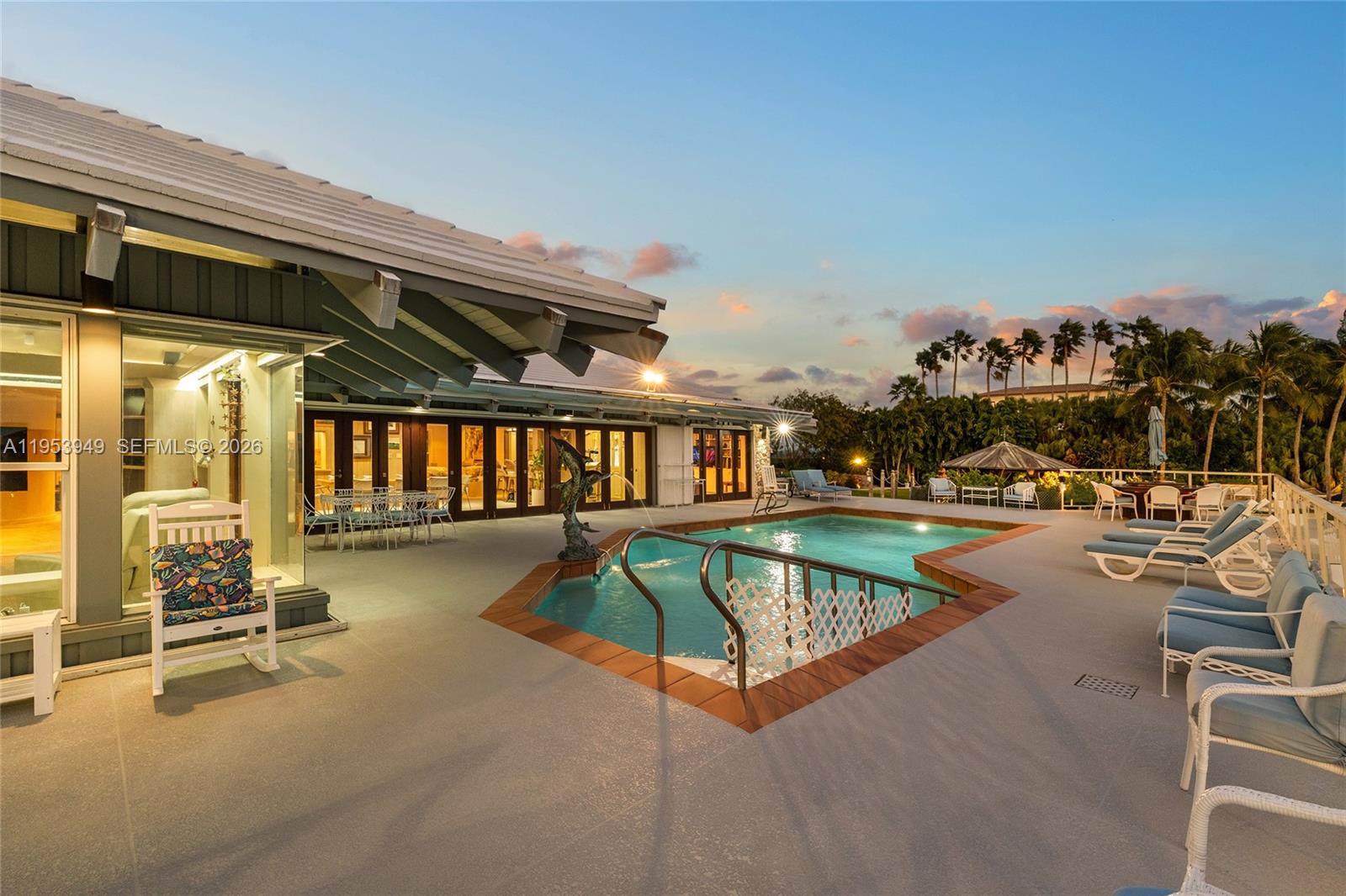 720 Lugo Avenue Coral Gables, FL 33156 - Photo 12 of 71 a view of a swimming pool with a lounge chair