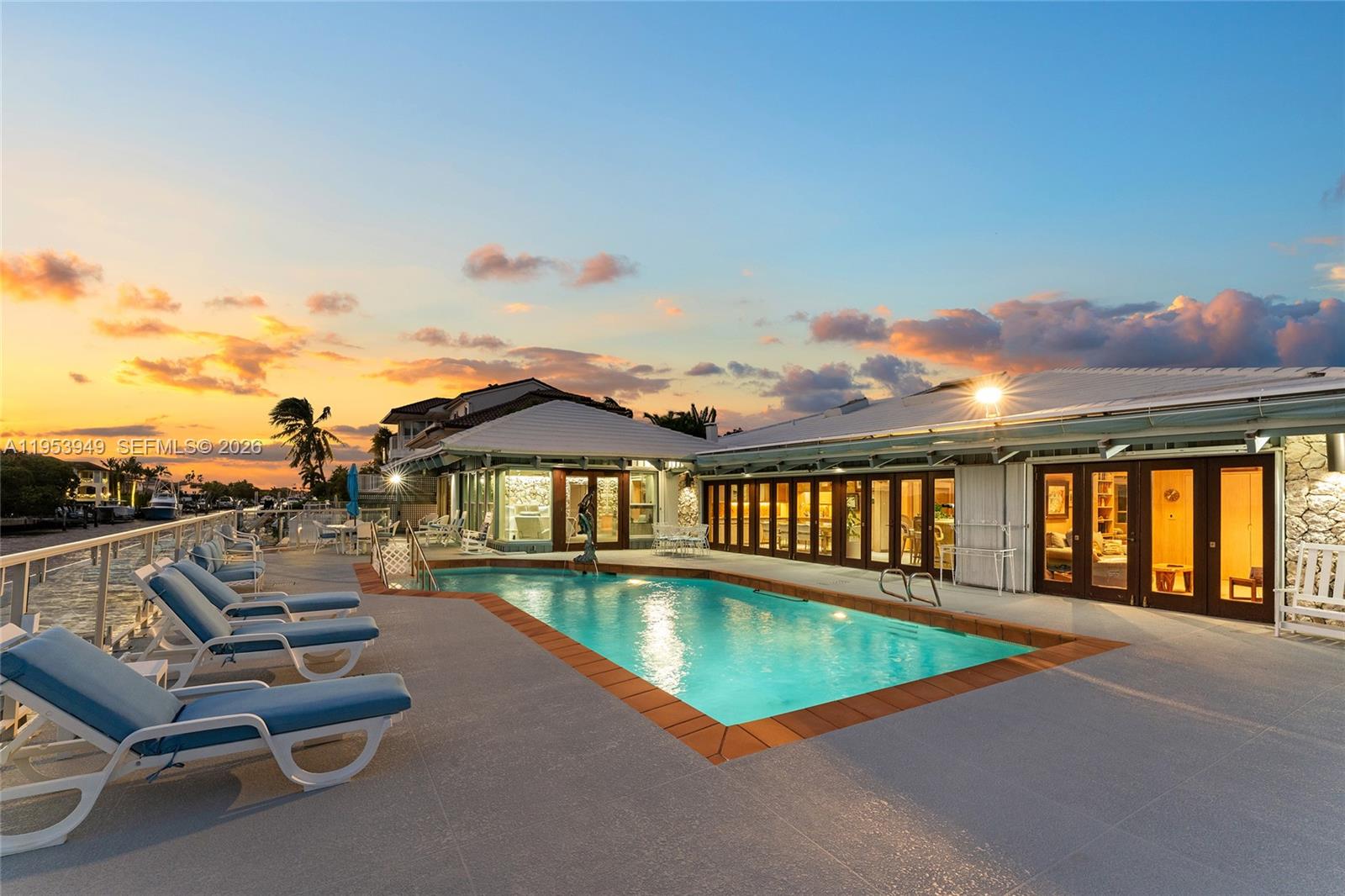 720 Lugo Avenue Coral Gables, FL 33156 - Photo 13 of 71 a view of a swimming pool with a lounge chair