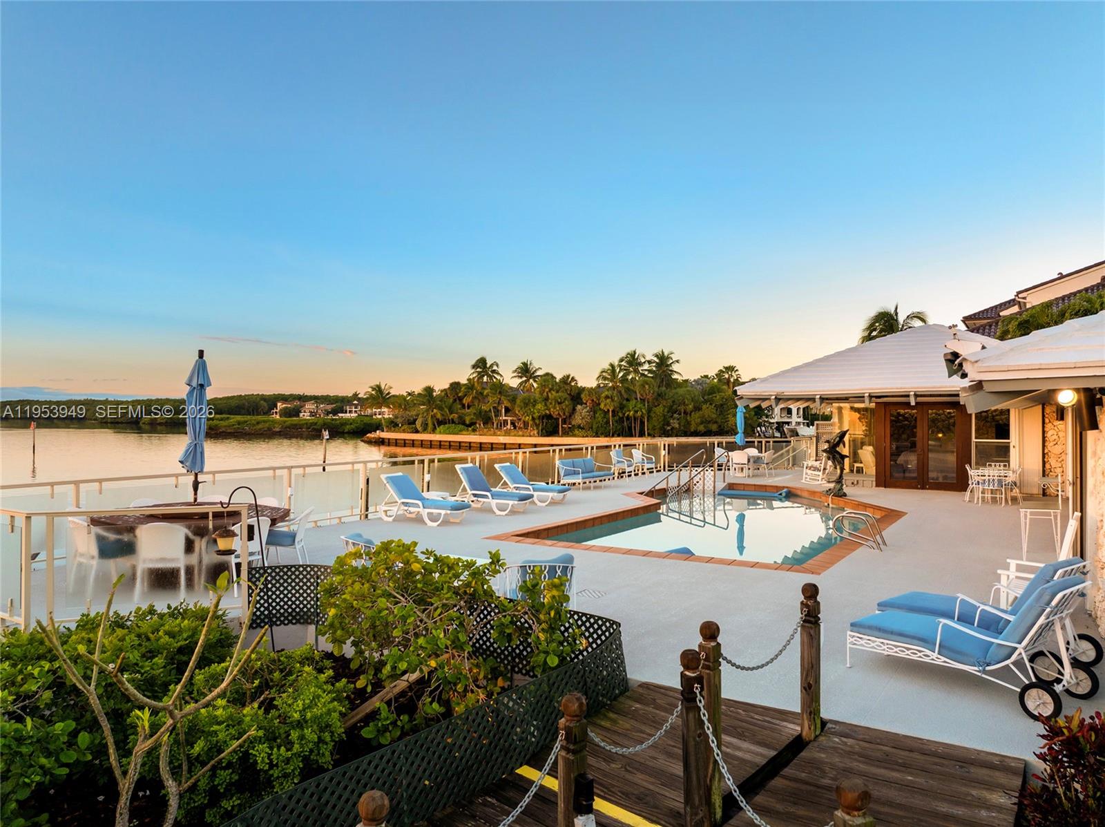 720 Lugo Avenue Coral Gables, FL 33156 - Photo 15 of 71 a view of a swimming pool with lounge chairs