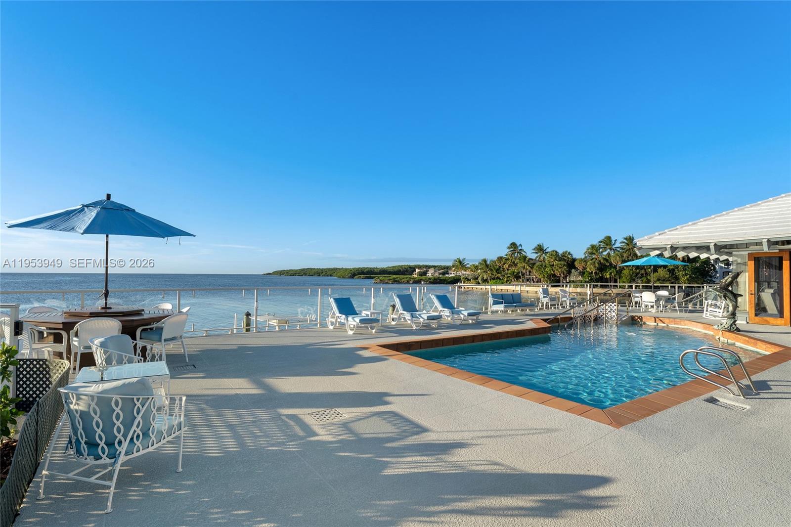 720 Lugo Avenue Coral Gables, FL 33156 - Photo 16 of 71 a view of a swimming pool with an outdoor seating