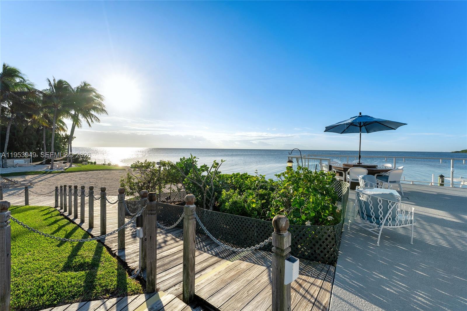 720 Lugo Avenue Coral Gables, FL 33156 - Photo 22 of 71 a view of a chairs and table in patio with wooden fence