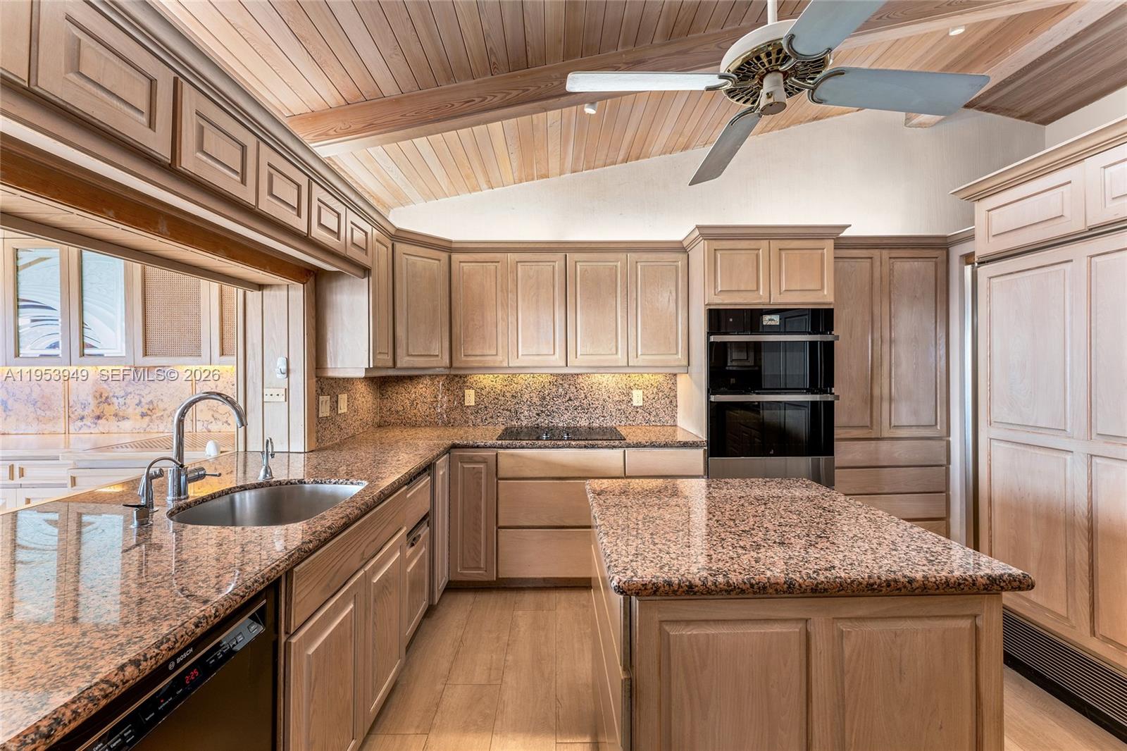 720 Lugo Avenue Coral Gables, FL 33156 - Photo 47 of 71 a kitchen with stainless steel appliances granite countertop a sink a stove and cabinets
