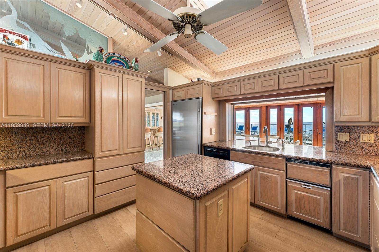 720 Lugo Avenue Coral Gables, FL 33156 - Photo 48 of 71 a kitchen with granite countertop a sink and cabinets