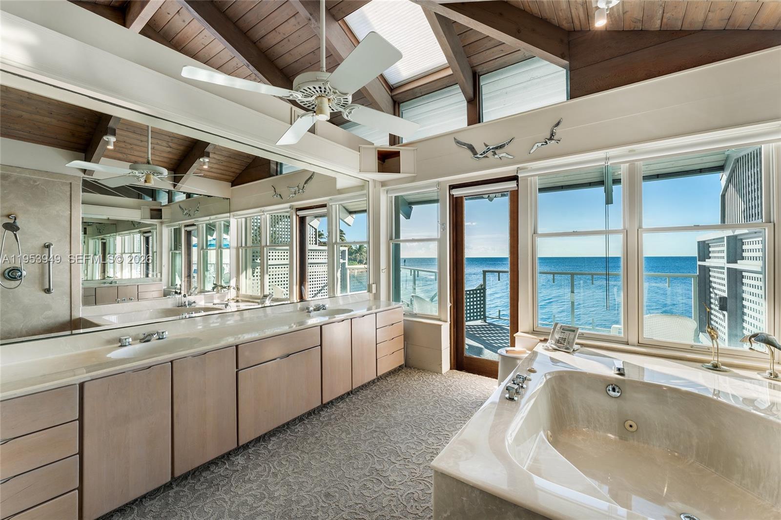 720 Lugo Avenue Coral Gables, FL 33156 - Photo 53 of 71 a large white tub sitting in a bathroom next to a sink