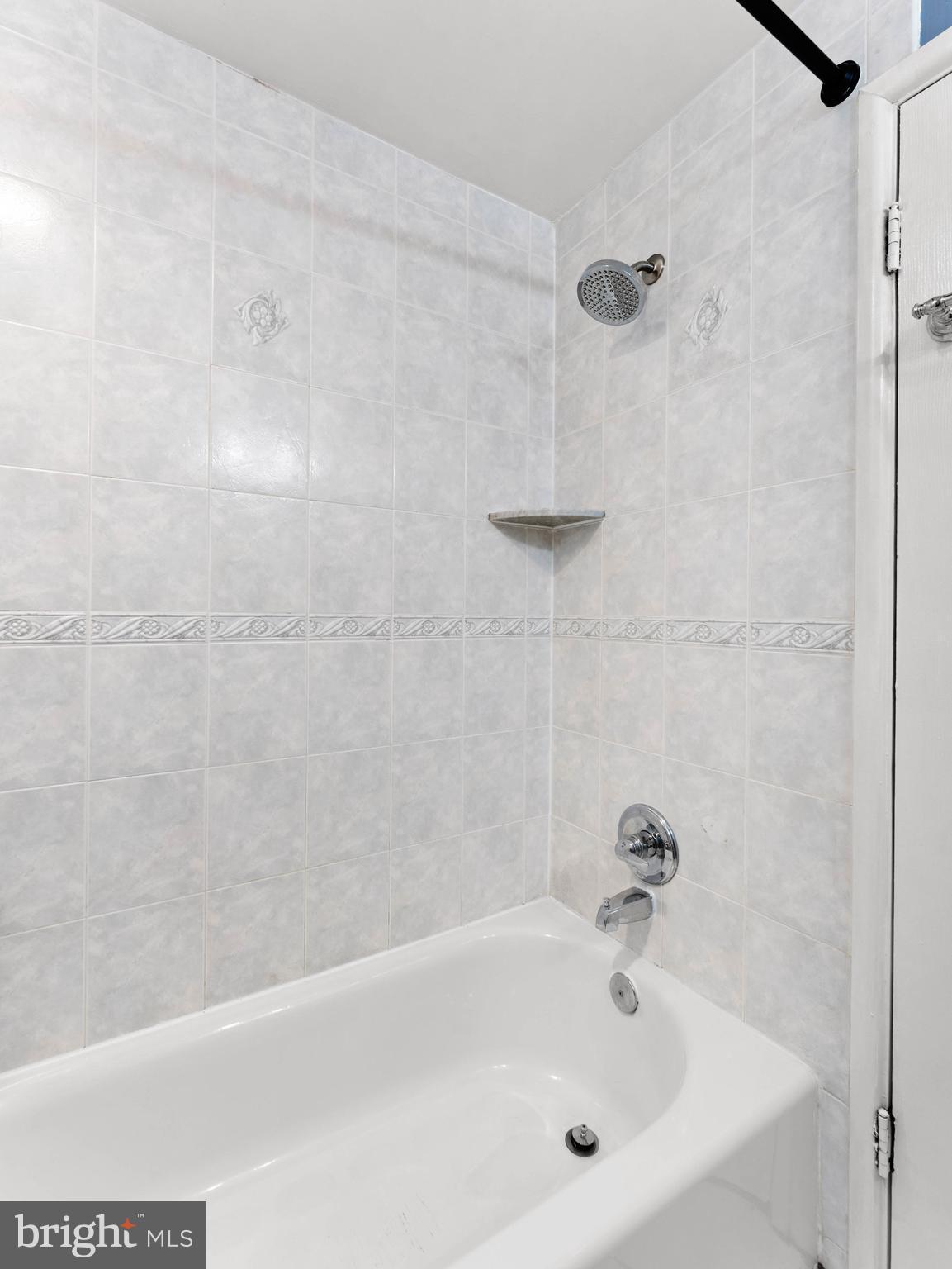 10839 Rayland Road Philadelphia, PA 19154 - Photo 21 of 30 a white bath tub sitting next to a white sink and vanity