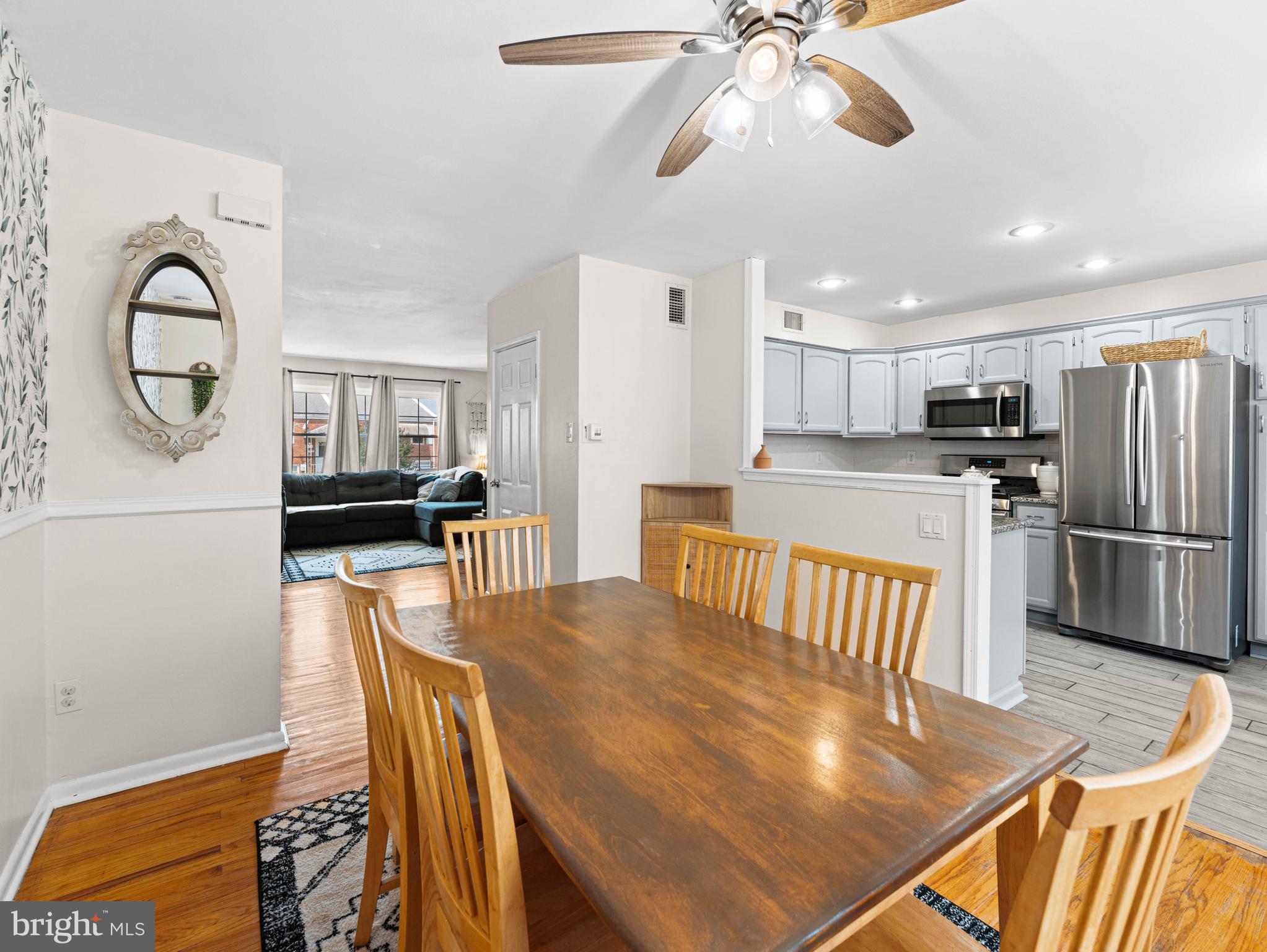 10839 Rayland Road Philadelphia, PA 19154 - Photo 8 of 30 a kitchen with stainless steel appliances granite countertop a refrigerator a stove a sink a dining table and chairs with wooden floor
