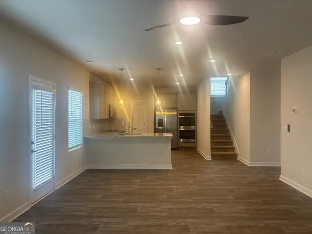 a view of a hallway with wooden floor