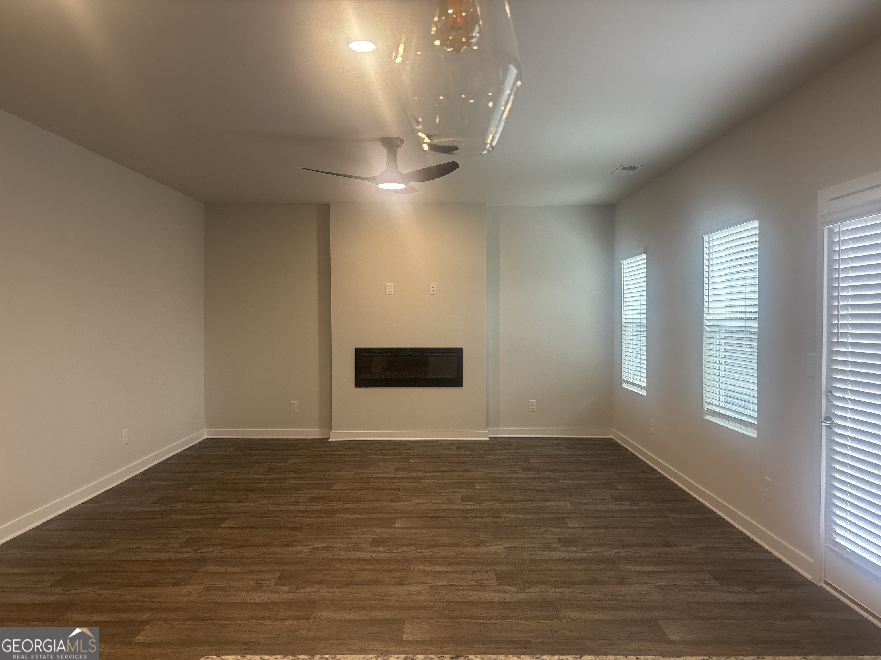 5367 Tolar Road South Fulton, GA 30213 - Photo 12 of 29 an empty room with wooden floor and windows
