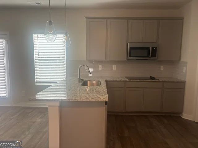 a kitchen with stainless steel appliances granite countertop a sink and a stove