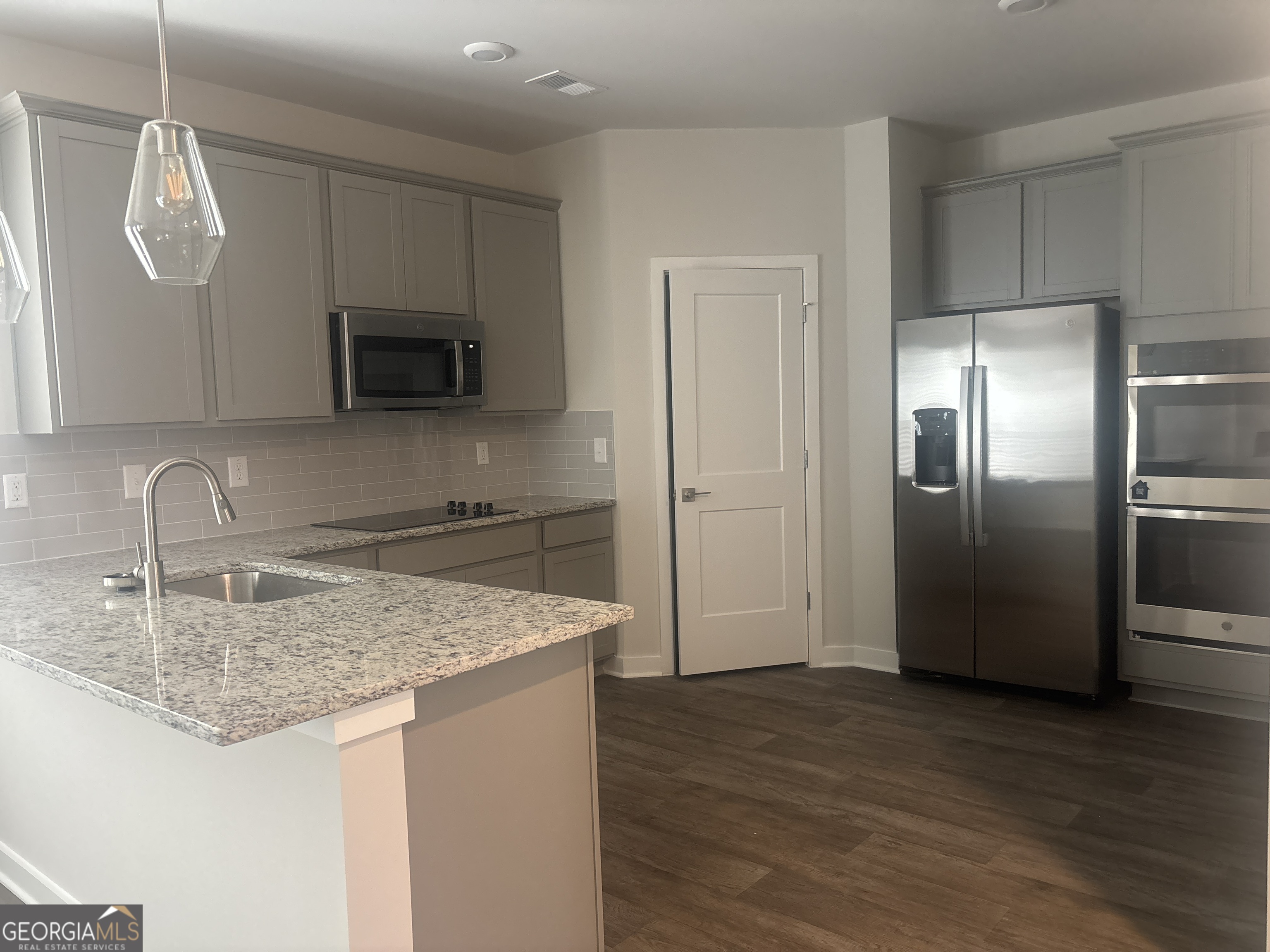 5367 Tolar Road South Fulton, GA 30213 - Photo 10 of 29 a kitchen with stainless steel appliances granite countertop a kitchen island a refrigerator sink and microwave