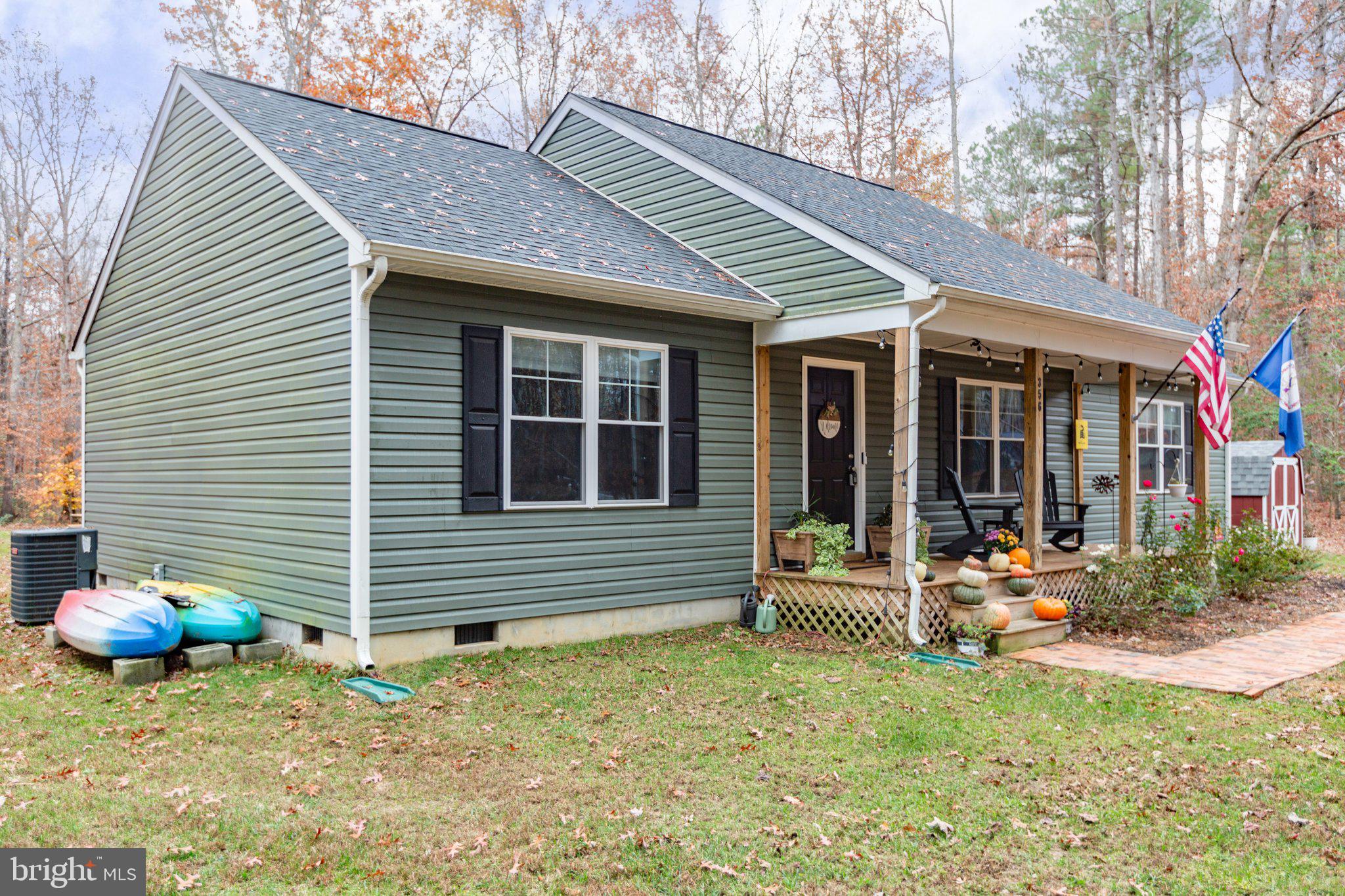 356 Greenes Corner Road Bumpass, VA 23024 - Photo 3 of 41 Bold forest green vinyl siding and black shutters