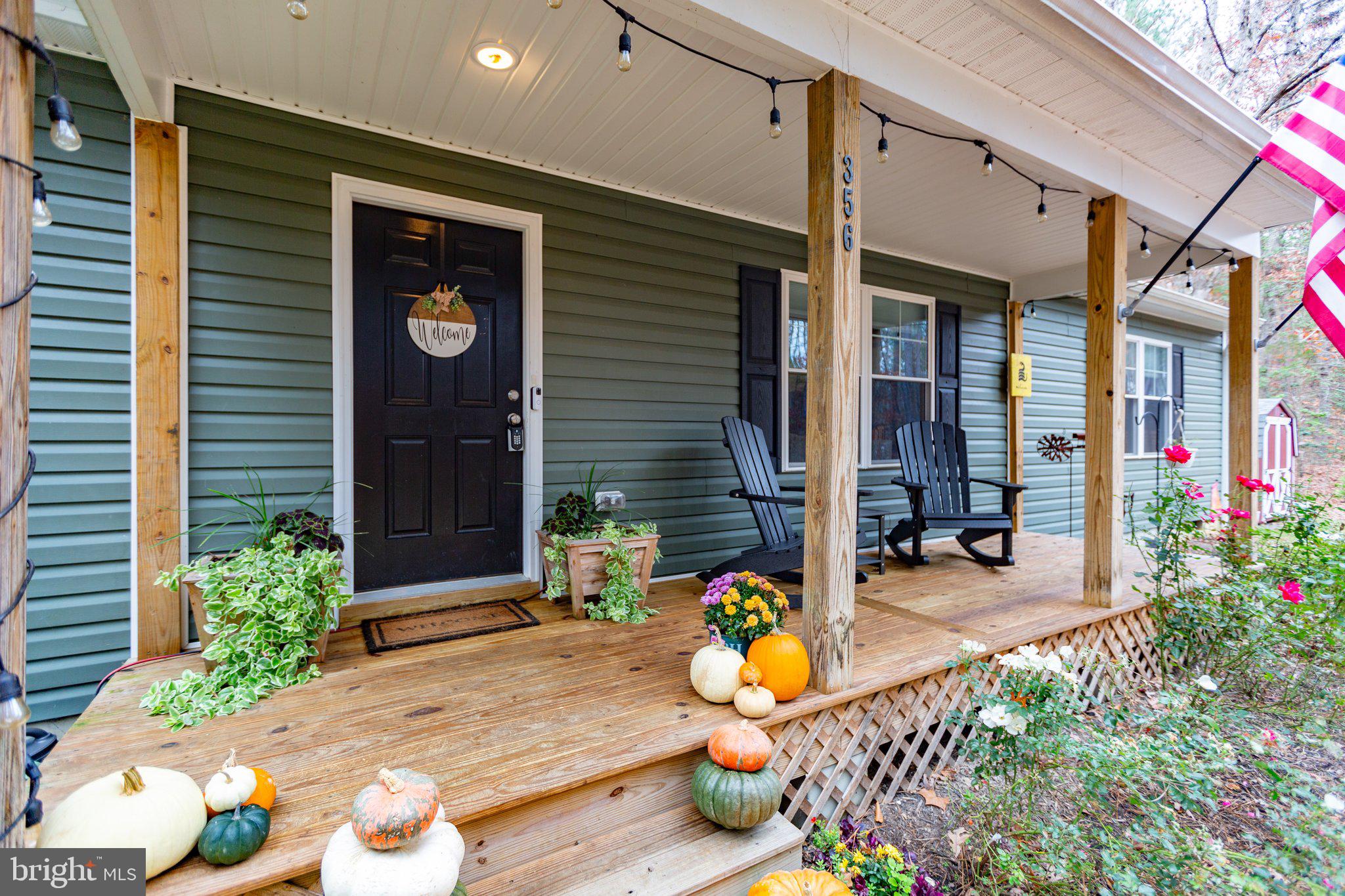 356 Greenes Corner Road Bumpass, VA 23024 - Photo 6 of 41 Cozy, natural wood front porch
