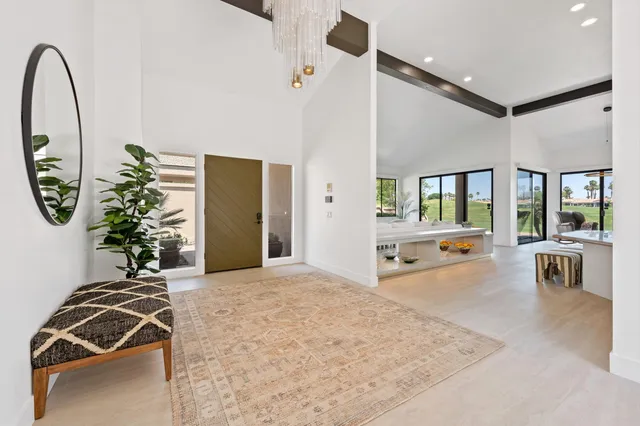 a view of a livingroom with furniture and mirror