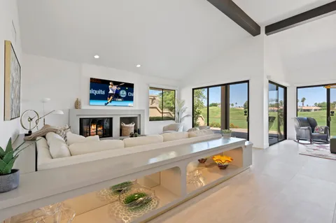 a living room with furniture fireplace and flat screen tv