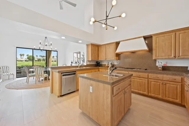 a kitchen with granite countertop a sink appliances cabinets and furniture