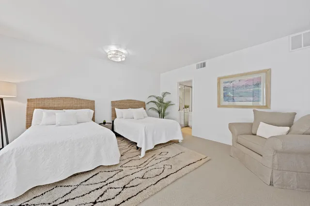 a bedroom with a large bed and a couch