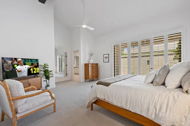 a bedroom with furniture and a large window
