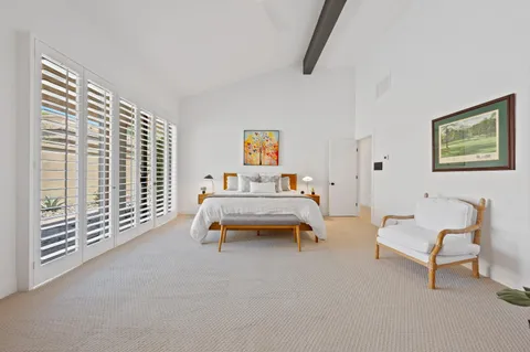 a large white kitchen with a large window