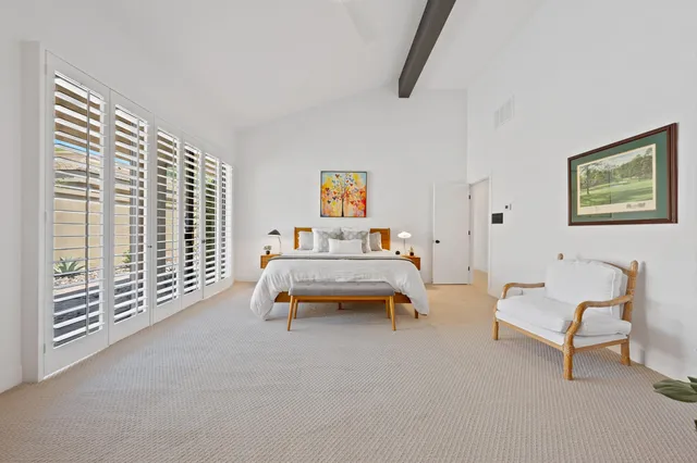 a large white kitchen with a large window