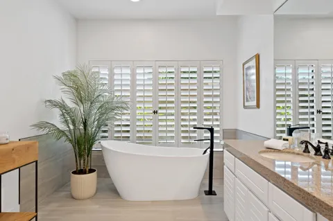 a bathroom with a shower sink and mirror
