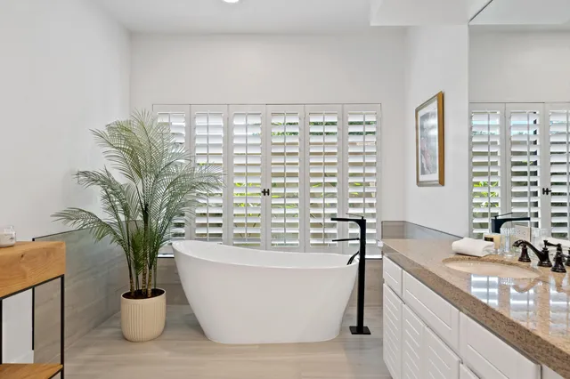 a bathroom with a shower sink and mirror